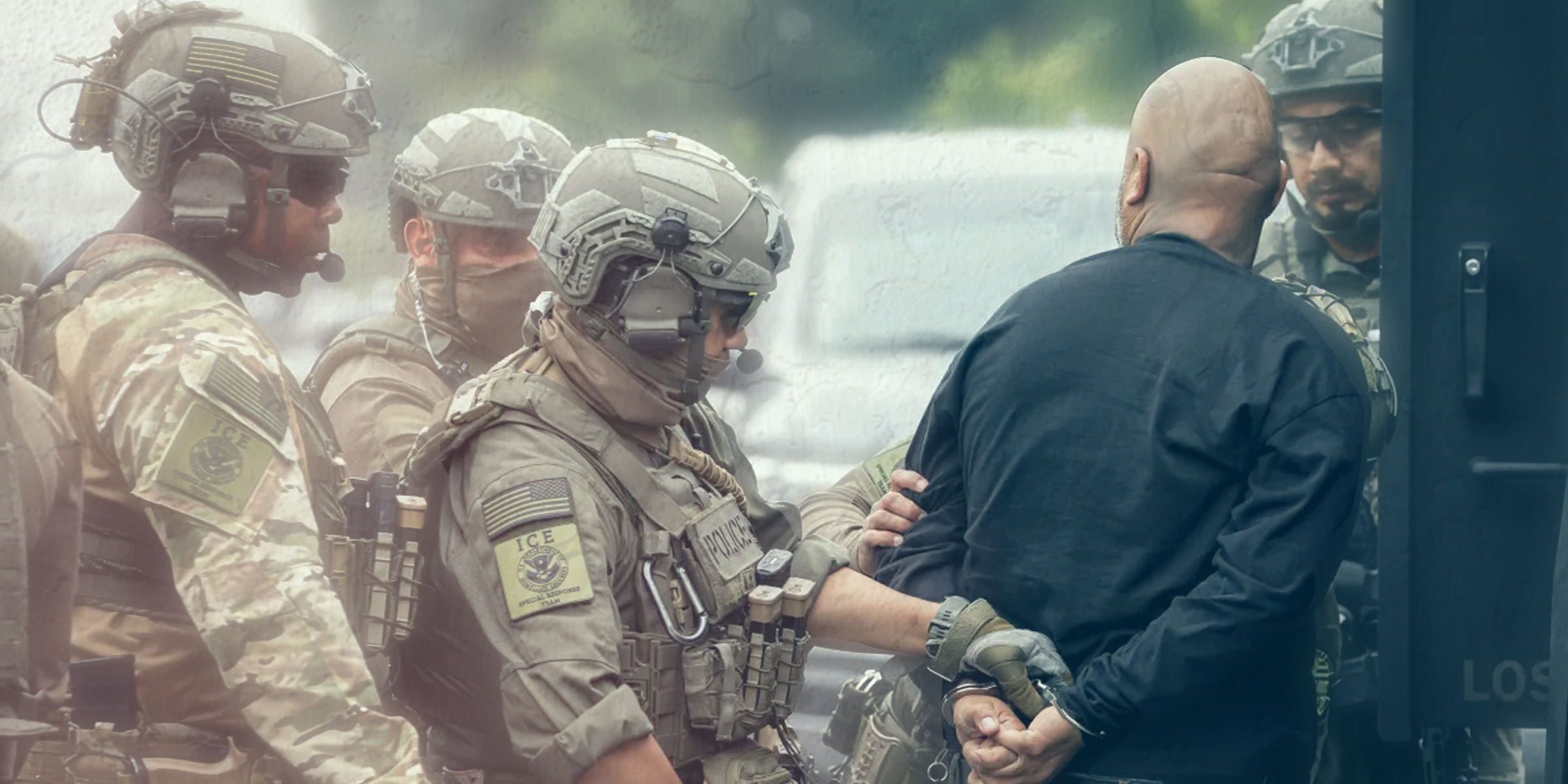 Immigration Customs and Enforcement officers in camouflage surround and handcuff a person.